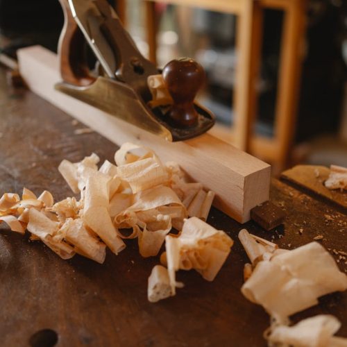 Jack plane and wooden plank on table